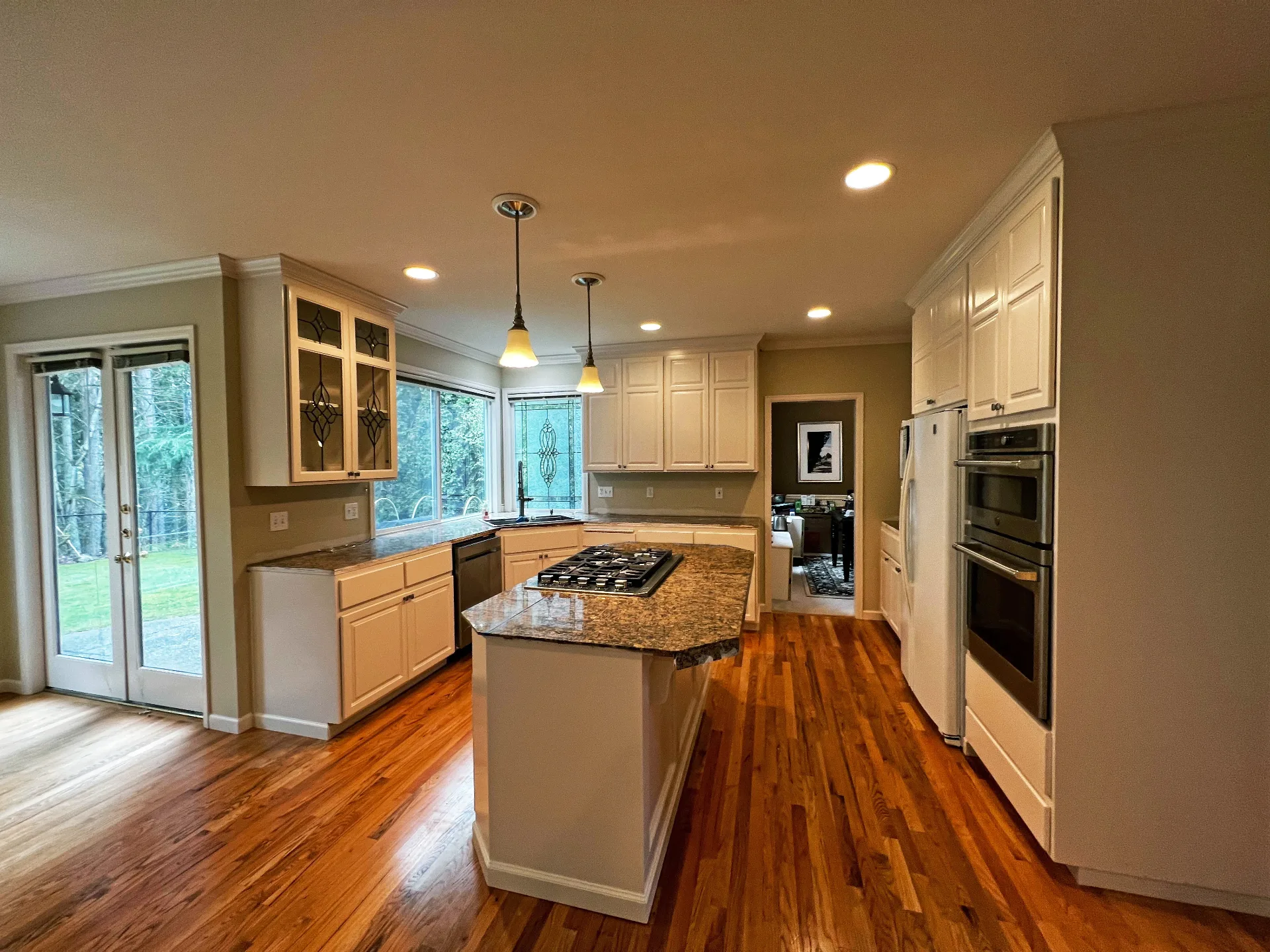 Freshly refinished kitchen cabinets with white finish