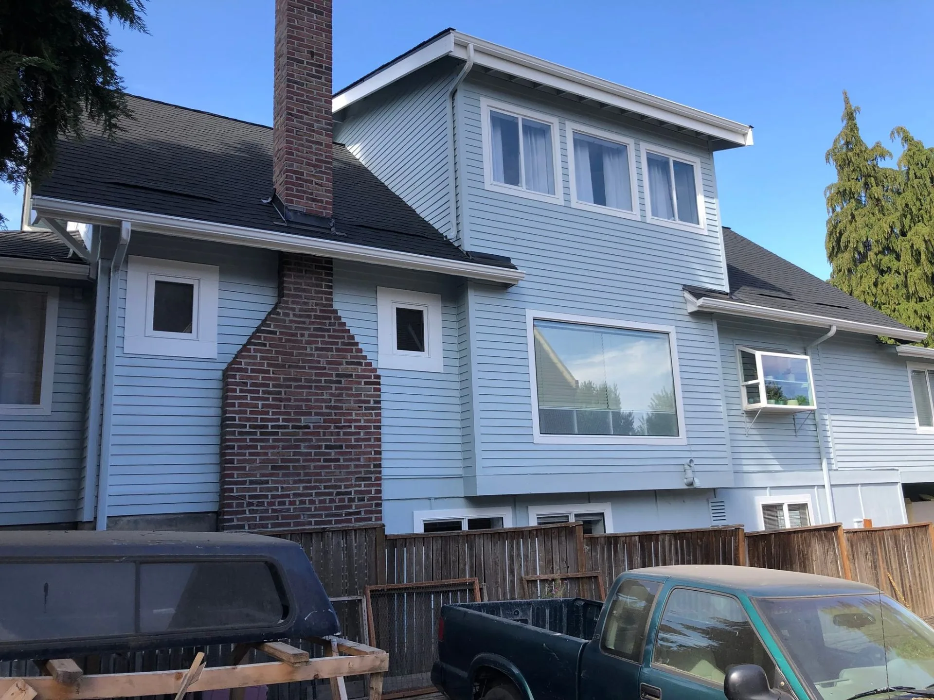 Light blue siding and white trim exterior painting completed