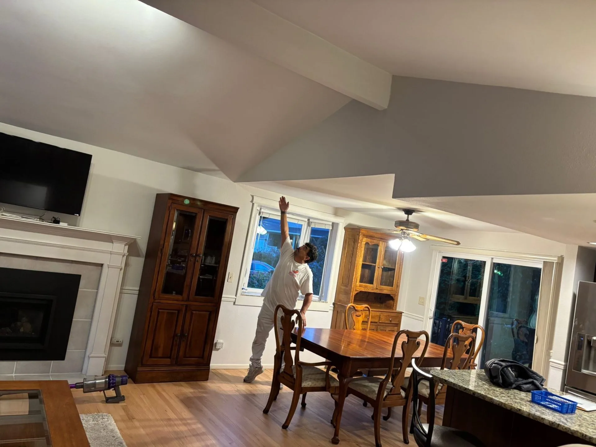 Painter working on interior ceiling painting project