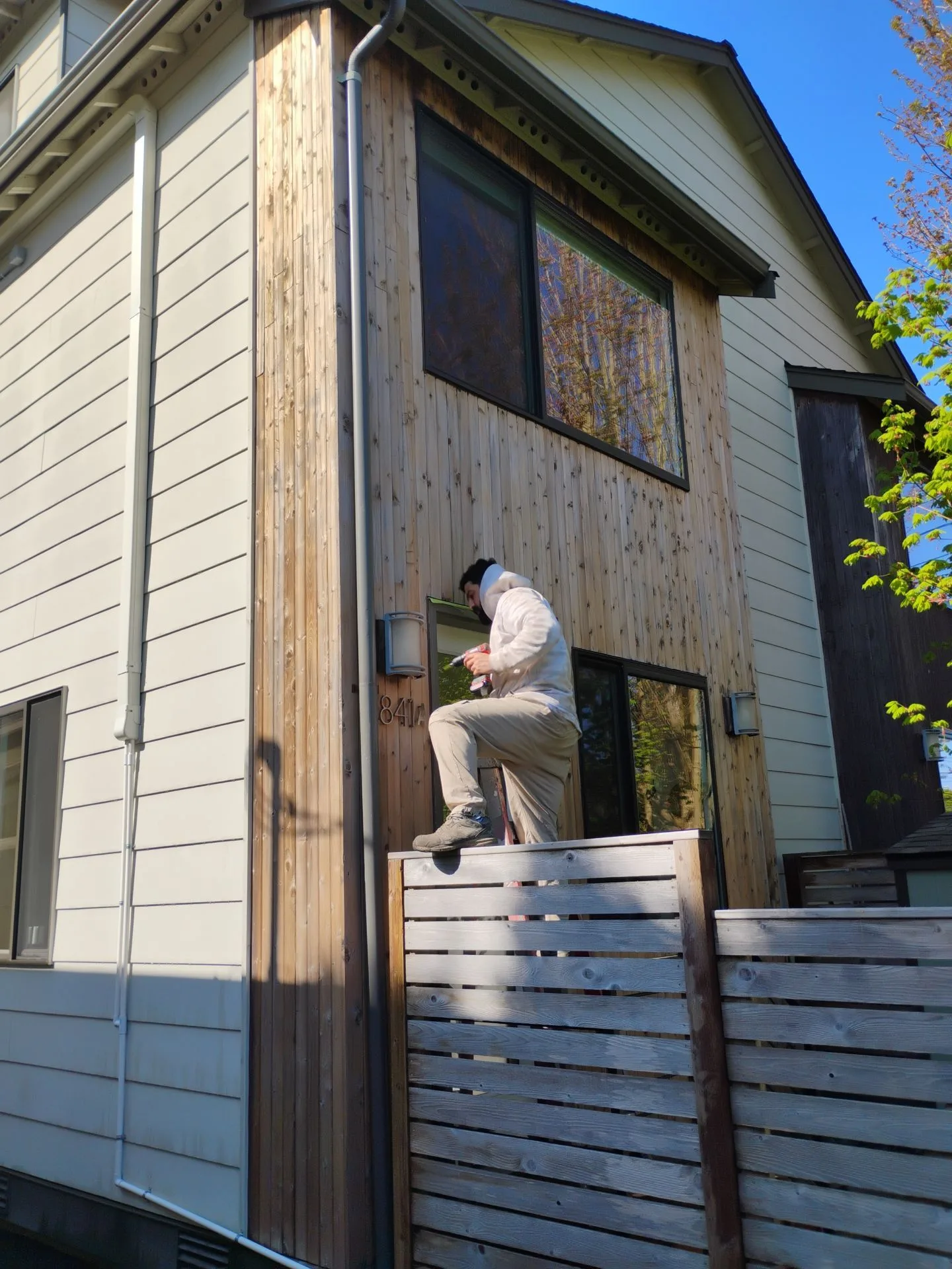 Arclight painter working on exterior staining detail