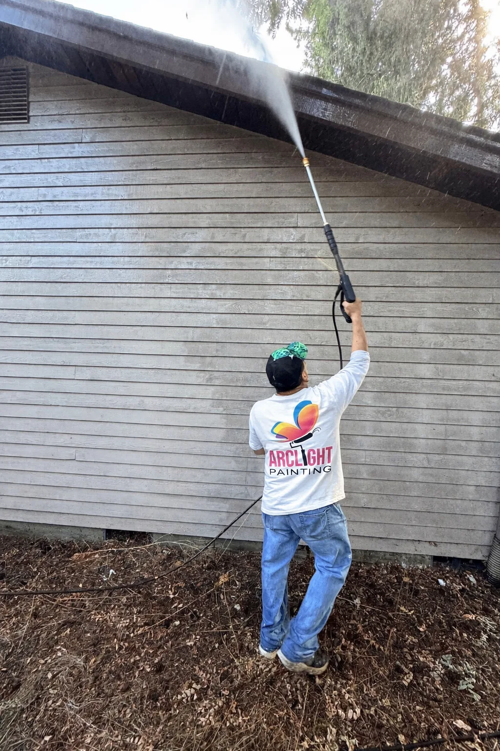Arclight Painting crew pressure washing house exterior siding in Bothell
